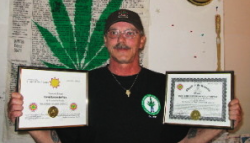 Ed Devries displays his ordination certificate as a minister of the Church of the Universe and the official charter for the Best Plant Believers Mission of Nunavut last year.